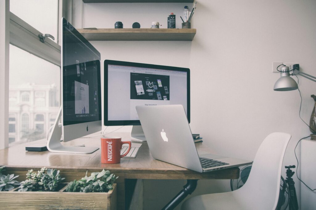 pexels-photo-245032-245032 Sleek home office setup with dual monitors, a laptop, and minimalist decor.